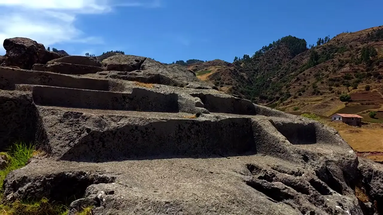 Rock-carved Puma Orqo figure has a broken head and long tail